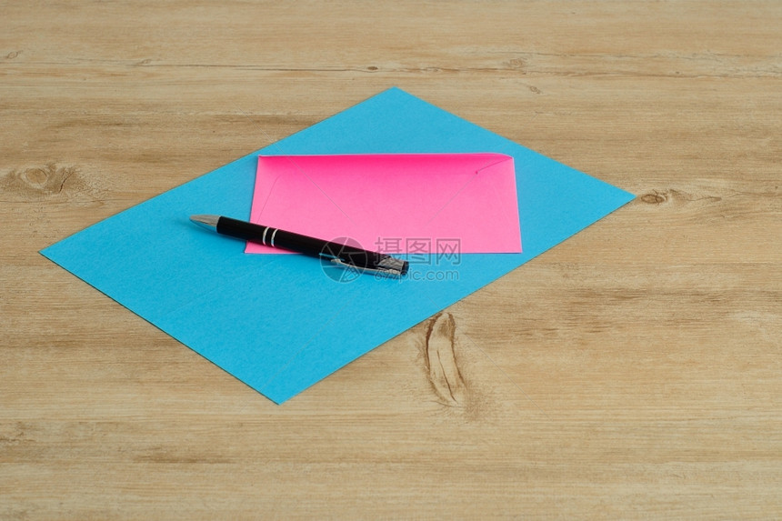 一张蓝纸和个带黑笔的粉红色信封问候一致丰富多彩的图片