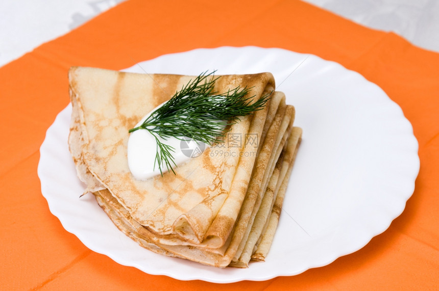 甜点一堆俄罗斯煎饼在白色盘子上美味的煮熟图片