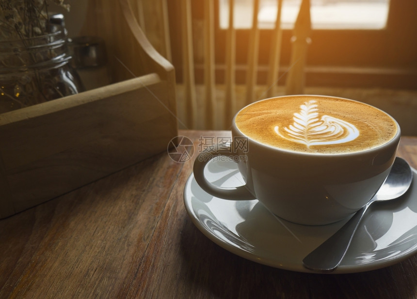 桌子白色的早餐热咖啡杯有温暖的清晨光窗图片