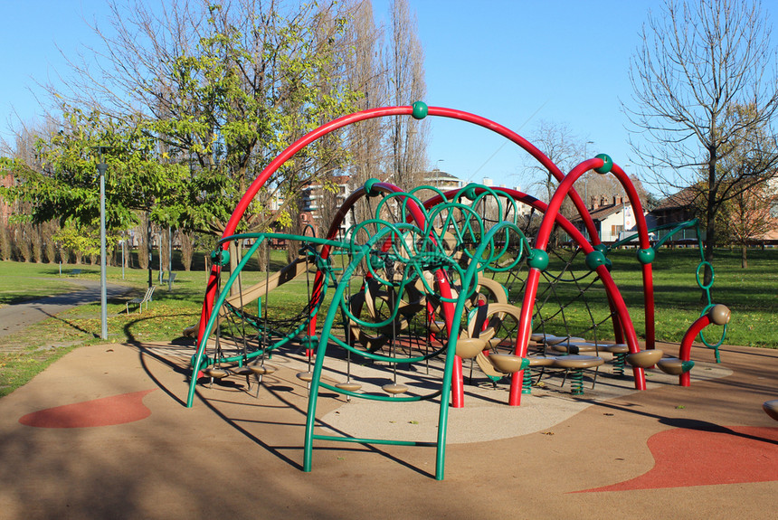 在公共园的多彩儿童游乐场活动空的树丰富多彩图片