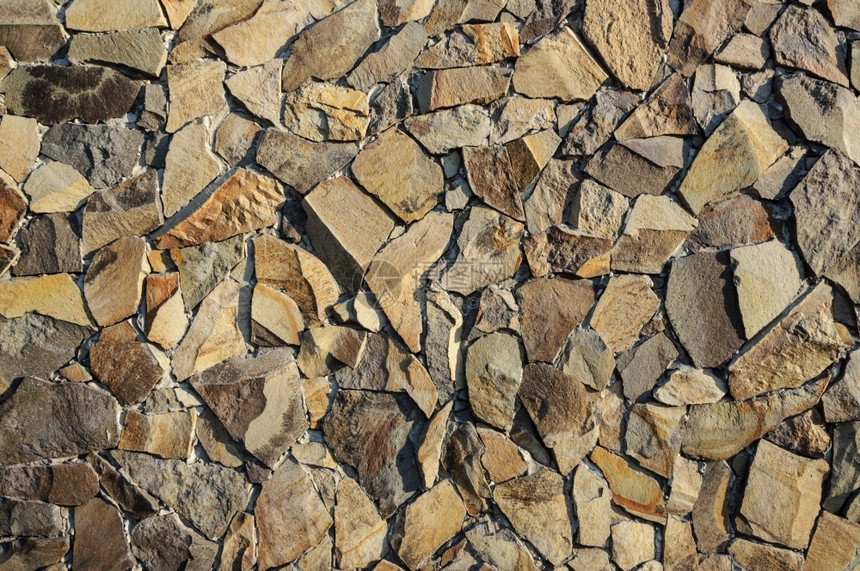 石墙表面的装饰褐色碎片结壳材料水泥图片