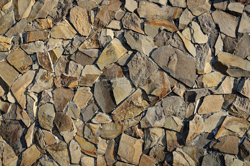 粗糙的装饰棕色粗石墙碎片质地水泥图片