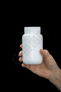 包装持有黑色背景隔离的赫纳德医生时用白塑料瓶装药医疗的健康图片