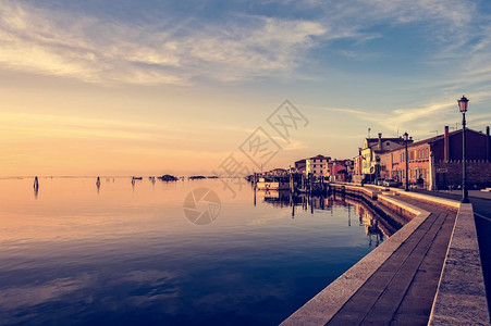 夏天小屋水威尼斯环礁湖岛佩列特里纳和城镇的浪漫日落图片