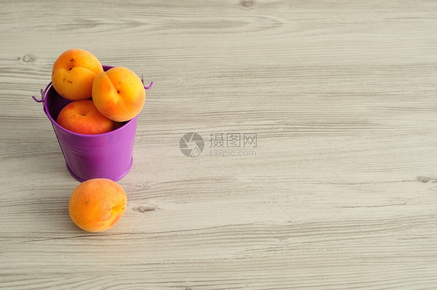 甜的下一个桶里装满了杏子旁边一个新鲜的图片
