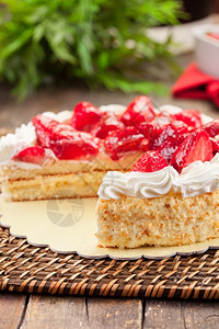 美味的草莓蛋糕木制桌上加奶油水果树叶图片