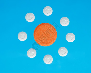 蓝底白橙和色药丸圆形的片剂背景图片