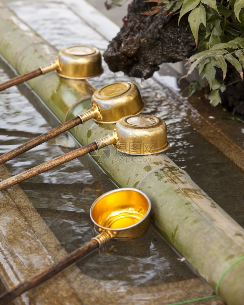 盆地钢包4个装满水的金属盘子正在等待用来净化朝拜者在东京新道神庙附近的手竹子图片