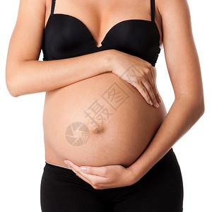 大约怀着黑色内衣和裤的手环绕着美丽怀孕妇肚子与世隔绝身体孩子图片