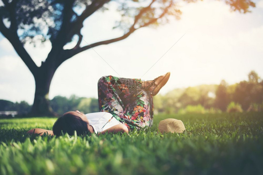 躺在草地上休息的年轻女孩图片