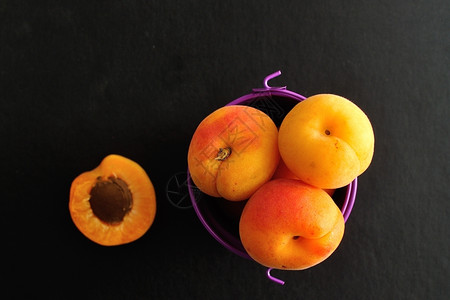 紫色桶中的杏子顶视图夏天黄色的可口图片