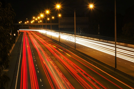 速度夜间交通灯在晚上沿高速公路或行驶驾快速地图片
