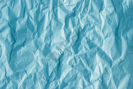 蓝色皱纸细节粗蓝包装纸背景材料和的碎色调背景