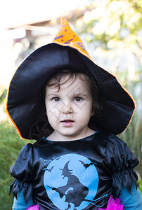 十月快乐的一个带着万圣节装扮的小女孩头上戴着黑帽子裙图片