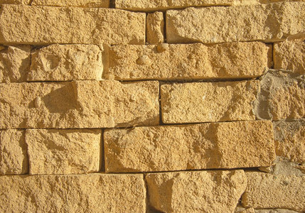 陈年黄色古老的石砖墙Stone原质纹理背景对齐位置水平的建造图片