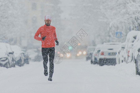 在雪天跑步的男性图片