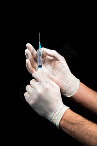 手放在乳胶套上黑背景持有注射器疫苗治愈图片