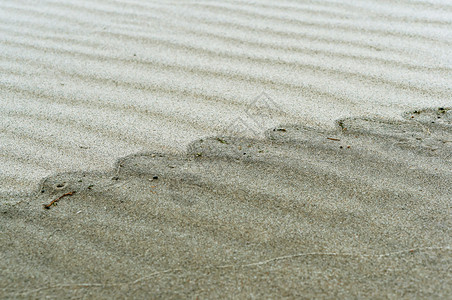棕色的沙波纹浪面质光滑的海岸波浪形沙面质光滑的海岸沙子波纹浪潮度图片