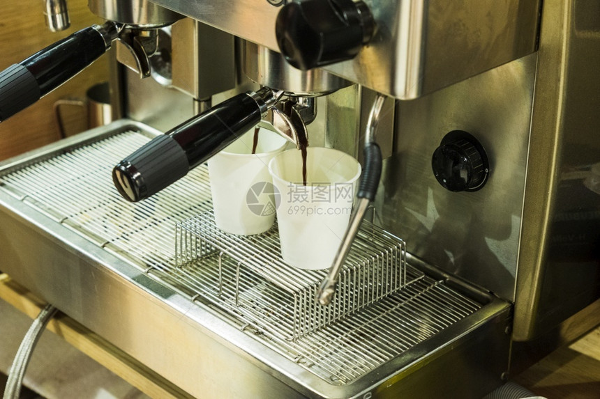 咖啡店一台机在纸板玻璃杯里装两咖啡白色的饮料图片