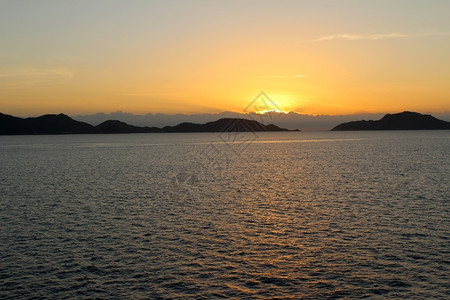 海浪滩岩石日落在中图片