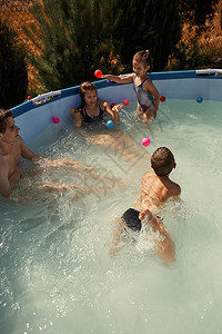 游泳玩耍夏日泳池里玩耍的家庭背景