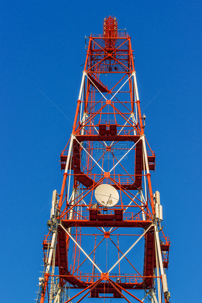 收音机联系无线的在一个大城市蓝天电视和无线塔背景上安装有天线的电信塔和一个大城市的无线电塔图片