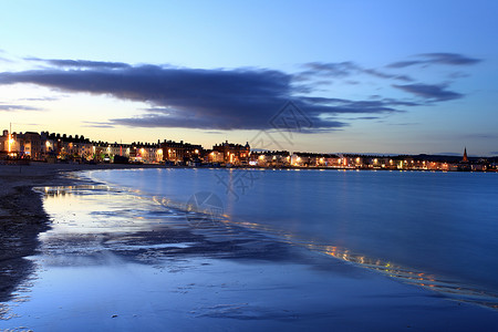 黄昏日出Dorset的韦茅斯海滩日落滨图片