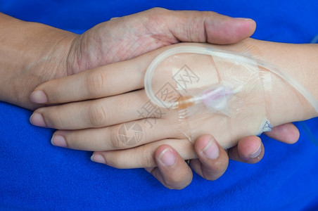 陈年健康将病人用IV管扶住医院提供护理爱和手高清图片
