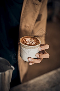 咖啡拿铁的艺术制作由酒吧咖啡拿铁的艺术制作咖啡店温暖的手图片