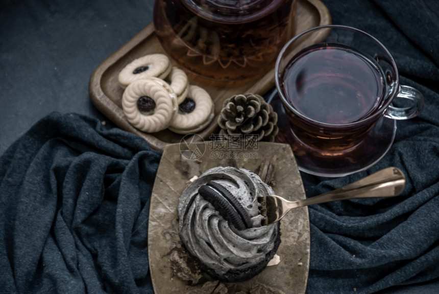 一种奥里蛋糕和一杯水果茶在深蓝色的布质上从顶部看杯子浆果图片