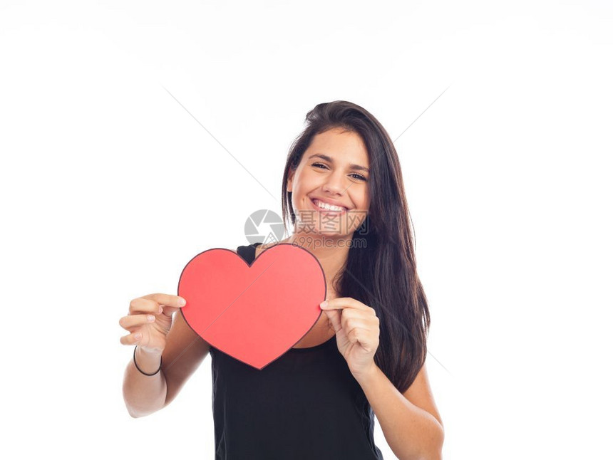 美丽的快乐年轻女子她拿着红心为情人节献祭日微笑红色的假期图片