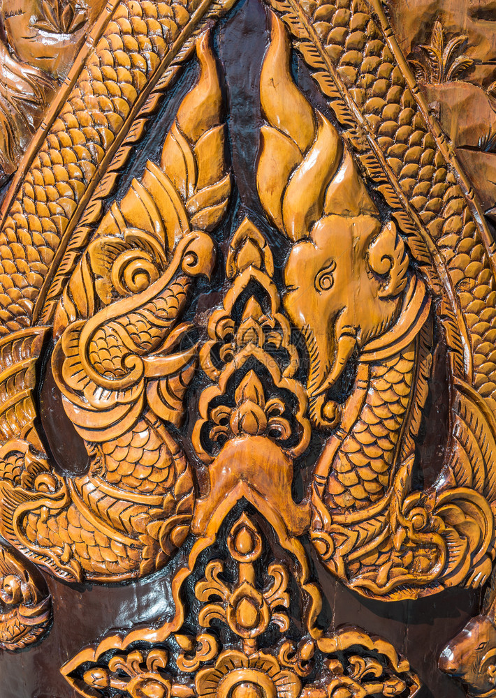 在泰国寺庙木柱上的老雕刻大象和龙艺术老的复古图片