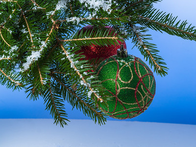 金子季节两个大圣诞球挂在树枝上传统的图片