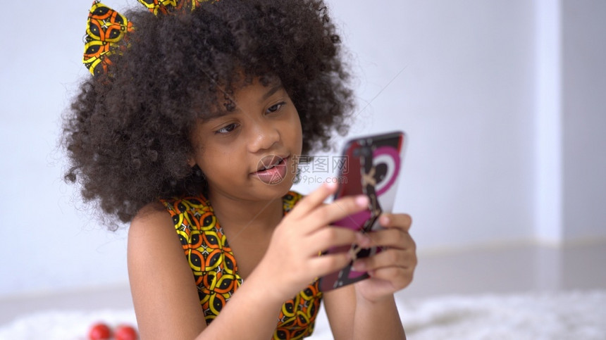 非洲人孩子移动的CuteAfrican美籍女孩在手机上制作自拍图片