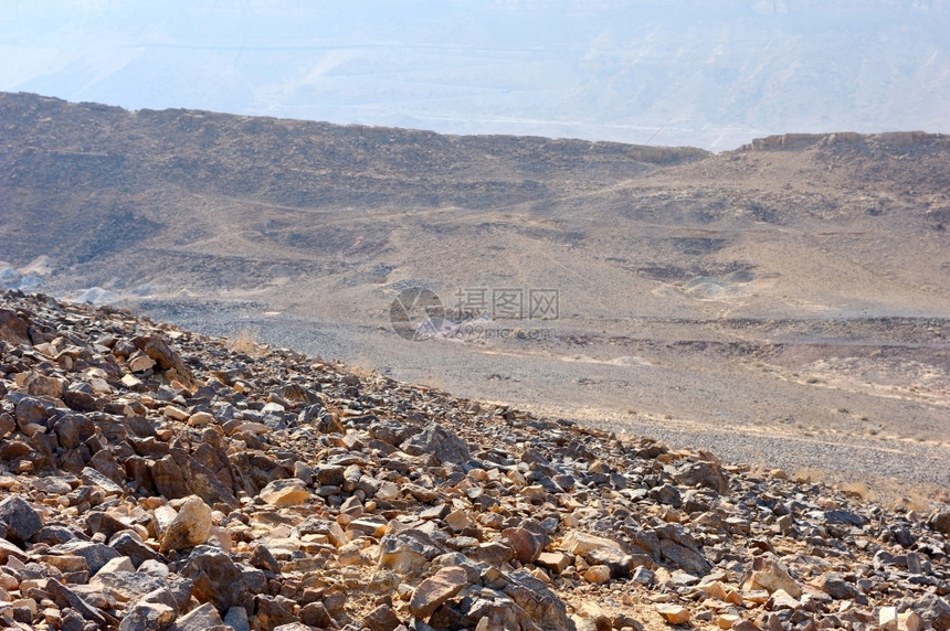 以色列独特的弹坑MakhteshRamon的石块蓝色棕黄图片