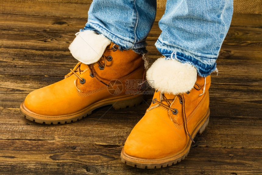 身穿冬靴和木制衣服牛仔裤的女子脚系统趾木制的图片