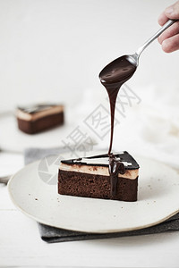 浇上巧克力酱的切片蛋糕图片
