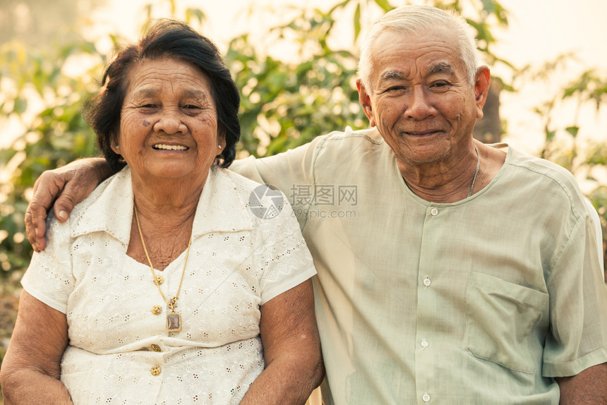日落时坐在户外的亚洲幸福老年情侣人亚洲享受图片