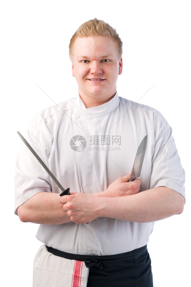 意图职业笑的厨师拿着刀和磨锋利的图片