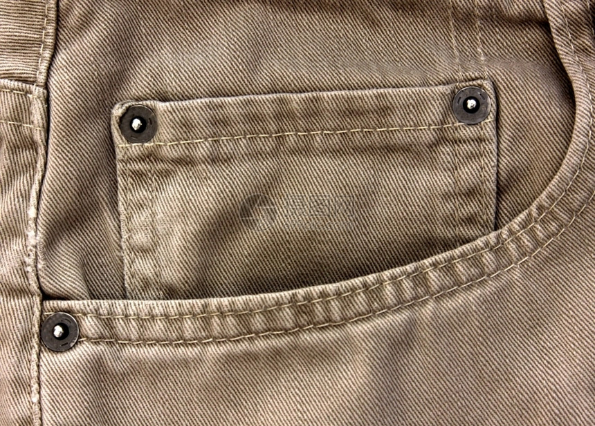 一种裤子浅褐色的米牛仔裤口袋的特写米色牛仔裤口袋图片