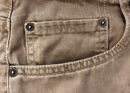 米口袋花一种裤子浅褐色的米牛仔裤口袋的特写米色牛仔裤口袋背景