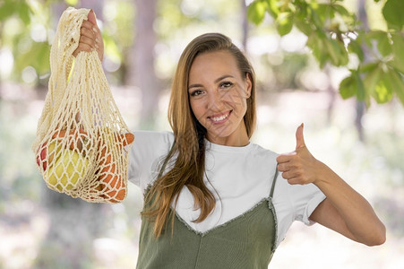 机器大拇指空白的女人用拇指在标志上做手脚生物可降解的袋子和甜点图片