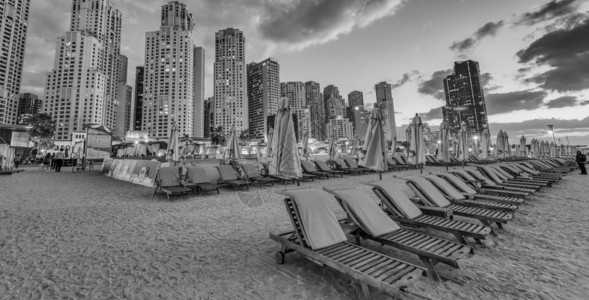 迪拜滨海滩的美丽日落与沙滩椅图片