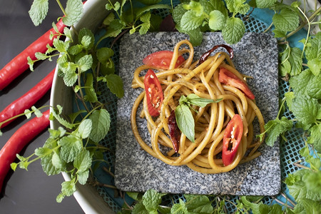 石锅上加辣椒的意大利面条热语食物图片