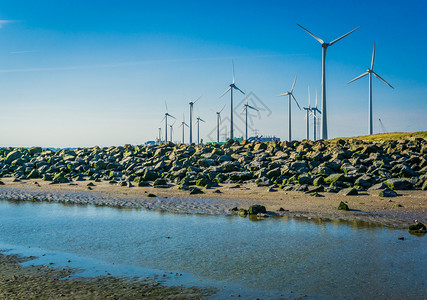 海滩远视带岩石和水的风力磨坊公园场地自然结石图片