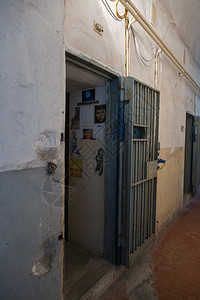 刑事金属惩罚牢房暗室的入口墙上挂着剪报监狱牢房的暗室墙上挂着剪报图片