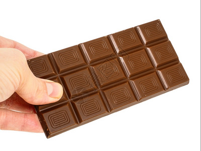 白色的一个人拿着整条光巧克力被白背景隔离在色上手食物图片