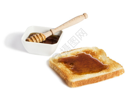 生的早餐营养丰富蜂蜜吐司罐勺吐司白色背景略顶图片