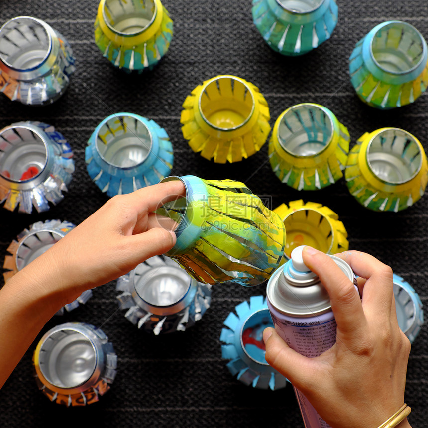 丰富多彩的秋天黄色妇女手工回收啤酒罐用切割和喷漆来回收啤酒罐在秋节中做灯笼图片