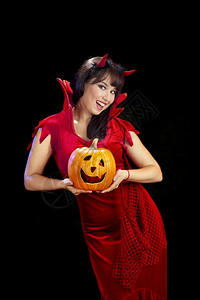 灯笼戏服女孩在嘉年华装扮恶魔拿着杰克欧斯柯兰特尔庆祝黑龙色的图片